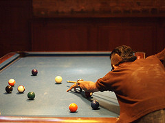 Billiard player ready to hit the ball