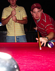 Man in red shirt striking the ball