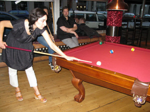 A lady playing billiards