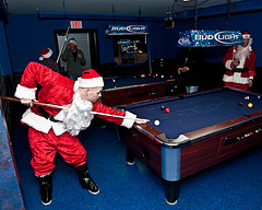 Santas playing bank pool