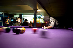 Billiards player hitting the ball